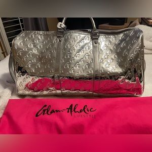 Glam-Aholic duffel bag silver. Comes with dustbag and crossbody strap.